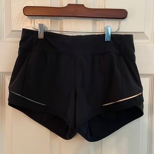 Lululemon size 6 shorts. Black. Flat waist band. Back zipper pocket. EUC